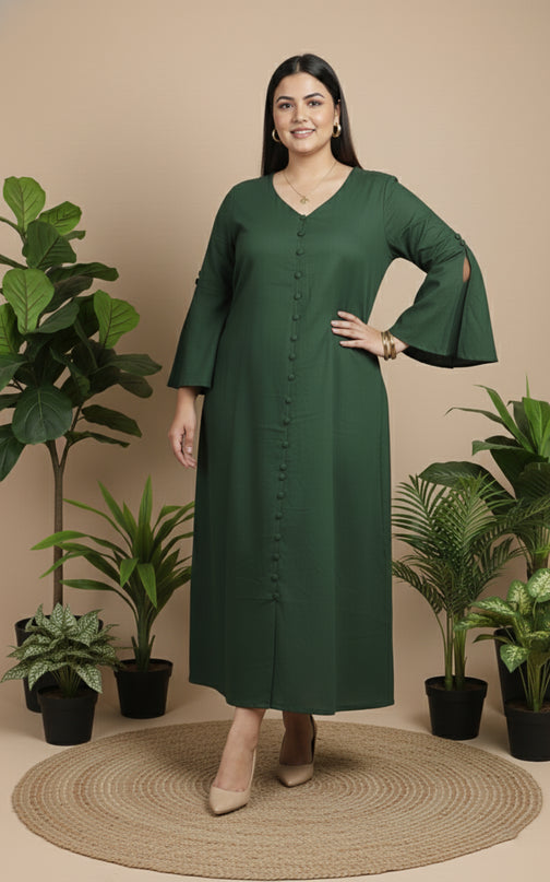 Woman wearing a green dress standing in front of potted plants on a beige background